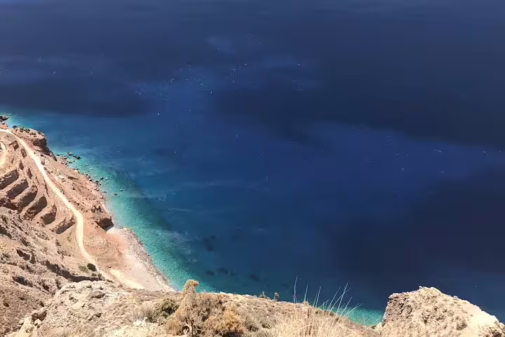 Stunning coastal view of turquoise seas along a rugged path on a 4x4 LandRover luxury private tour.