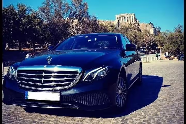 Luxury black limousine parked near the Acropolis in Athens for private city-to-Acropolis transfer service
