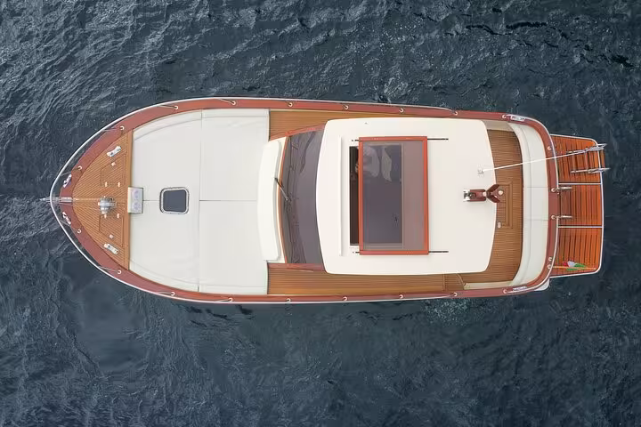 Aerial view of a luxurious boat cruising on the clear waters during an 8-hour private tour of Capri.