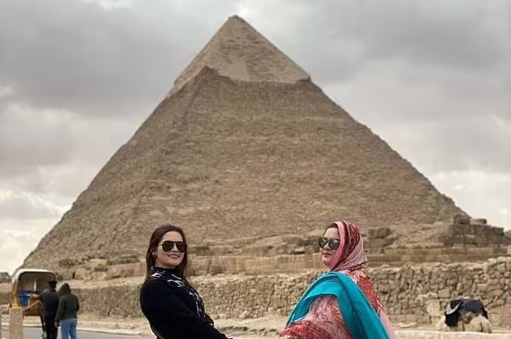 Guests at the Great Pyramid of Giza on a luxury Cairo Egypt tour with Four Seasons Hotel accommodation