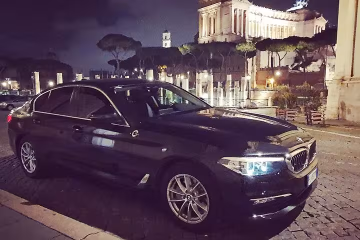 Luxury car in Rome at night, perfect for transfers from Civitavecchia port to Rome or airport, highlighting elegance.