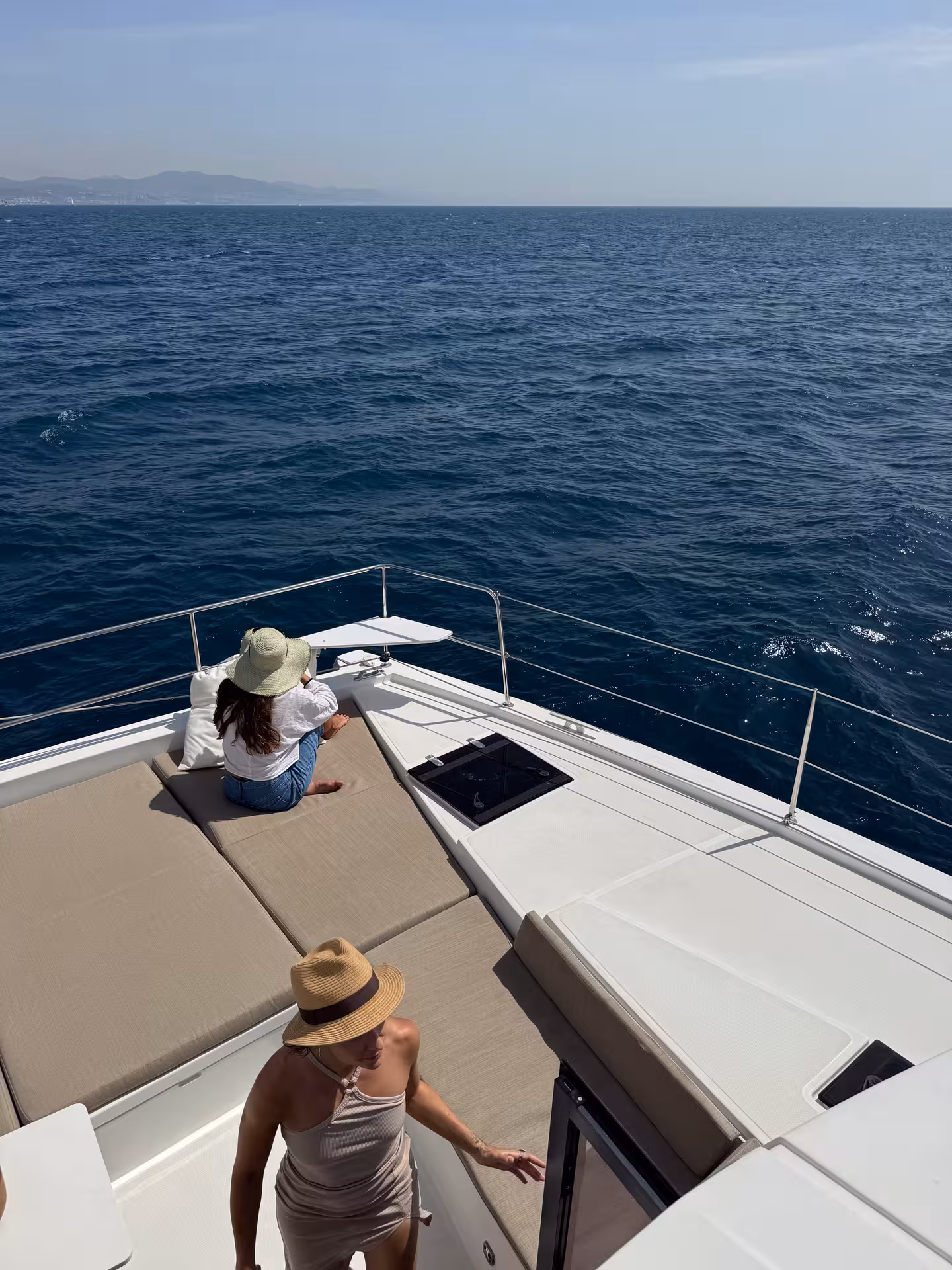 Guests relax on Bali 4.2 luxury catamaran bow during a 2-hour private Barcelona sailing cruise