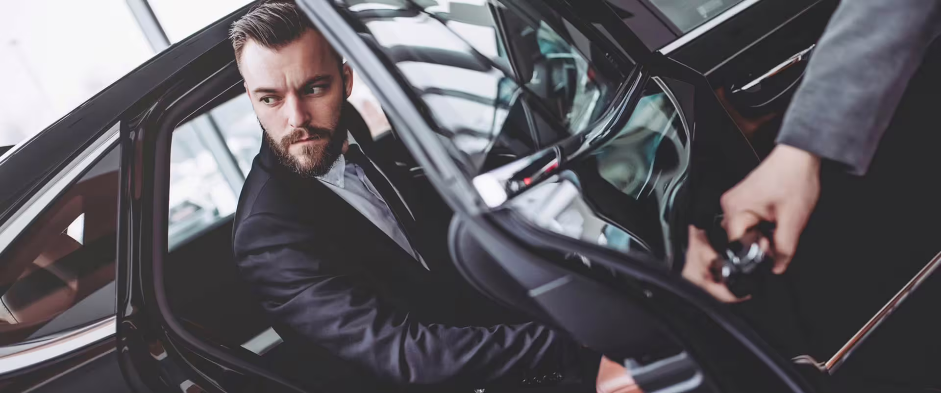 Business traveler stepping into a luxury private car for a professional transfer service from Naples to Pompeii or Herculaneum