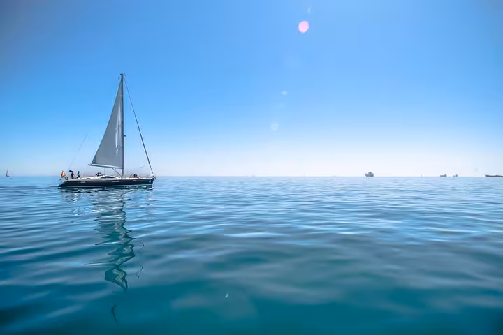 Luxury sailboat gliding on calm Mediterranean sea during a private Barcelona sailing tour for up to 12 guests
