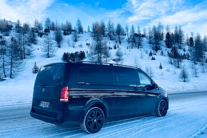 Luxury van traveling from snow-covered Cortina d'Ampezzo to Venice, highlighting scenic winter transfer service.