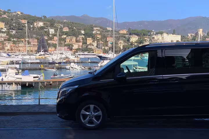 Luxury van parked by the scenic marina, ready for transfer from Ravenna Cruise Terminal to Bologna Airport.