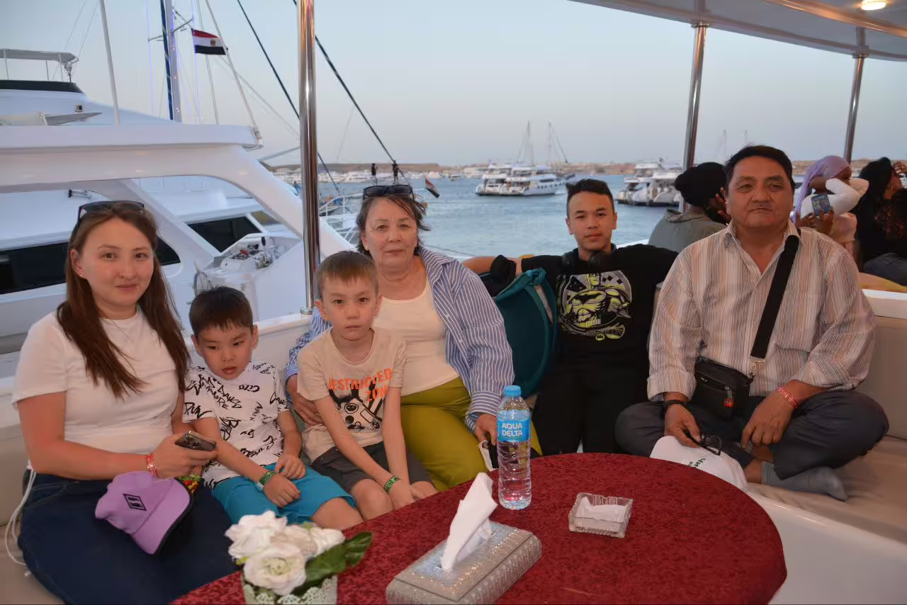 Family relaxing on luxury VIP boat in Sharm El Sheikh marina before dinner cruise with sea views