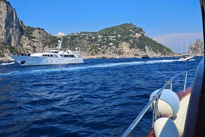 Luxury yacht cruising along the stunning cliffs of Capri during a private 8-hour boat tour.