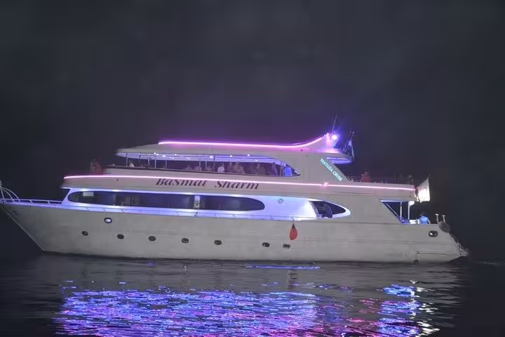 Luxury yacht lit at night on Red Sea for Sharm El Sheikh evening oriental dinner cruise with belly dance