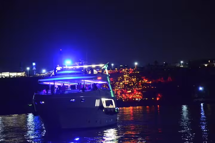 Luxury yacht on Sharm El Sheikh night dinner cruise, glowing lights over the Red Sea with onboard show