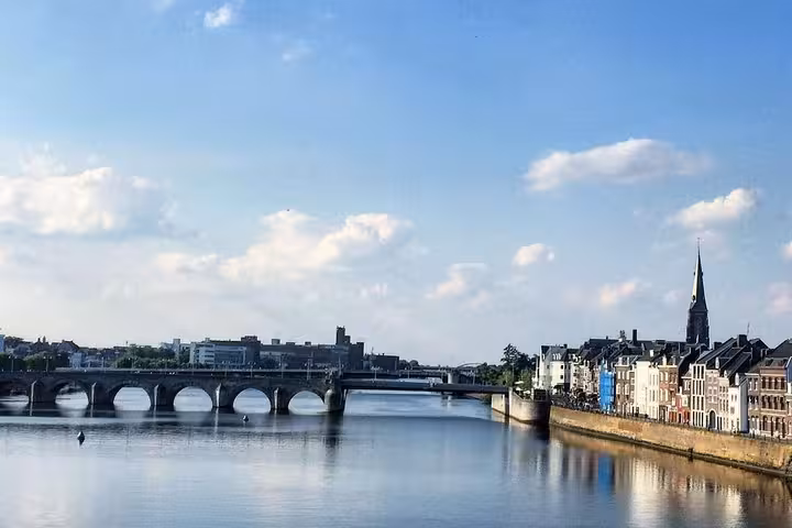 Maastricht riverfront and arched bridge view, ideal stop on Amsterdam Schiphol to Maastricht transfer tour