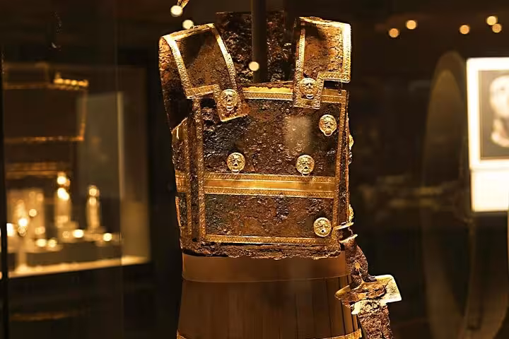 Golden Macedonian armor cuirass in museum display, featured on Alexander the Great private tour from Athens