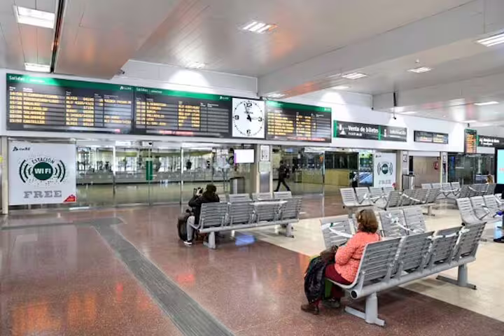 Madrid Chamartín train station arrivals hall with departure boards, meeting point for private transfer service