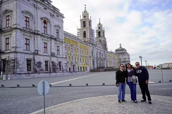 Tourists enjoying a visit to the majestic Mafra National Palace, a UNESCO World Heritage Site near Lisbon, Portugal.