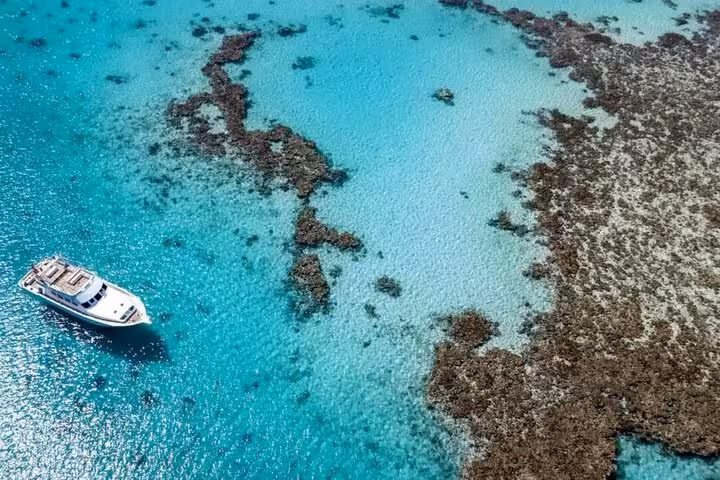 Boat cruising over Mahmya Island coral reefs in turquoise Red Sea, full-day snorkeling trip from Hurghada