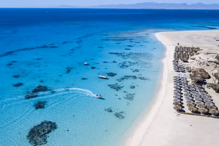 Aerial view of Mahmya Island from Hurghada, turquoise Red Sea reef patches and boats on snorkeling day trip