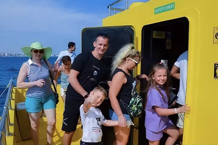 Family boarding the Royal Seascope at Makadi Bay marina for Red Sea semi-submarine tour and snorkeling trip