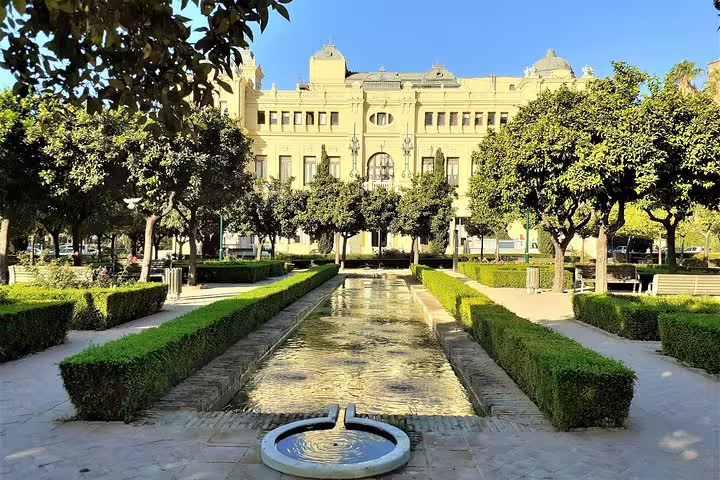 Malaga group walking tour view of Parque de Malaga gardens and fountain facing the historic Town Hall