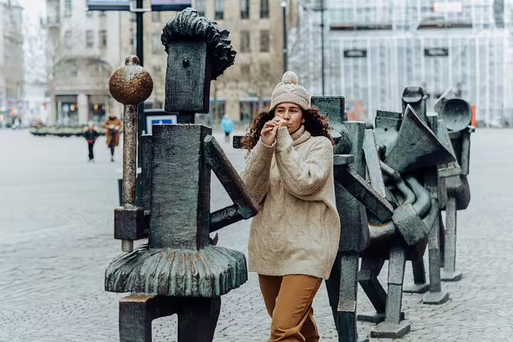 Woman exploring Malmö's unique sculptures on a private full-day trip from Copenhagen by train, highlighting cultural attractions.