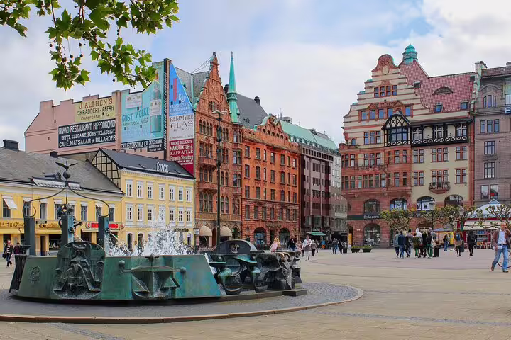 Vibrant Malmö square with historic architecture and fountain, perfect for exploring on a private full-day train trip from Copenhagen.