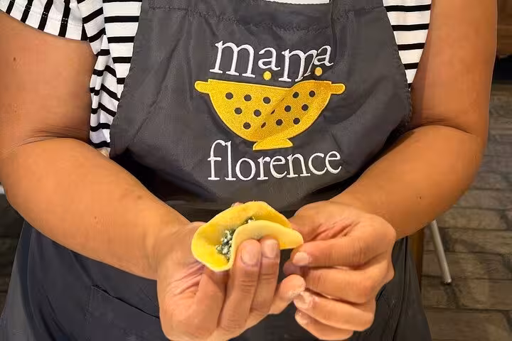 Close-up of hands making pasta during MaMa Florence's guided market tour and cooking class in Florence.