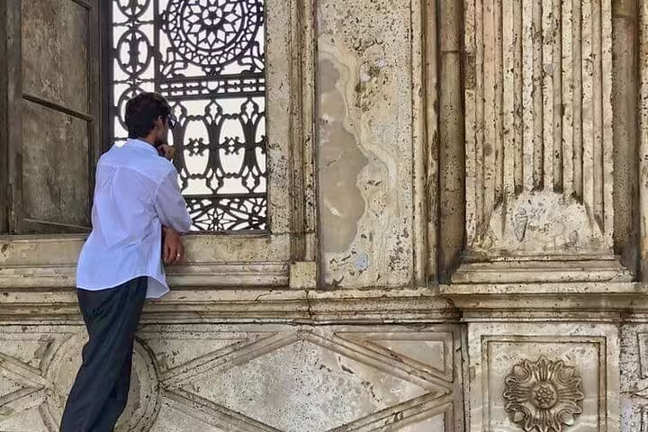 Man admiring ornate stonework and lattice window at Cairo Citadel on National Museum to Citadel & Bazaars tour