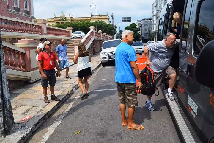 Travelers boarding shuttle van in downtown Manaus for airport transfer service to hotels and city addresses