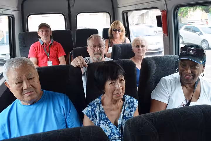 Passengers seated inside a comfortable shuttle van for Manaus airport to city transfer service with luggage space