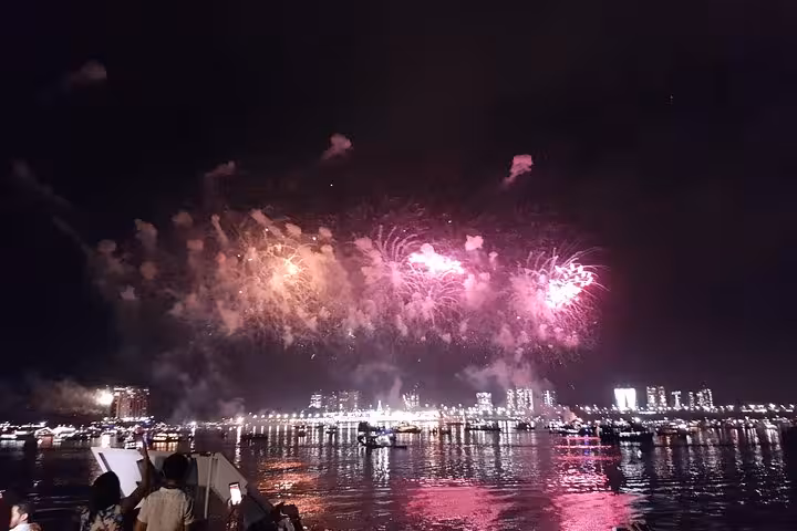 Reveillon fireworks over Manaus waterfront seen from a boat cruise on the Amazon River, Brazil New Year’s Eve