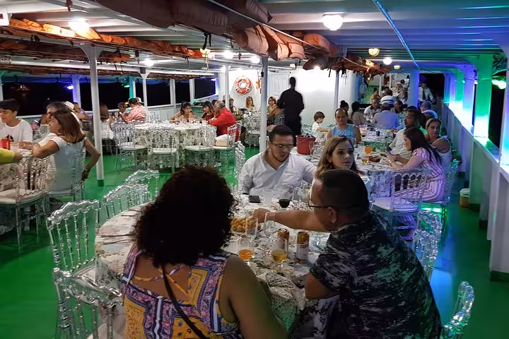 Dinner seating on Manaus Reveillon boat cruise with buffet, open bar tables and guests celebrating on the Amazon