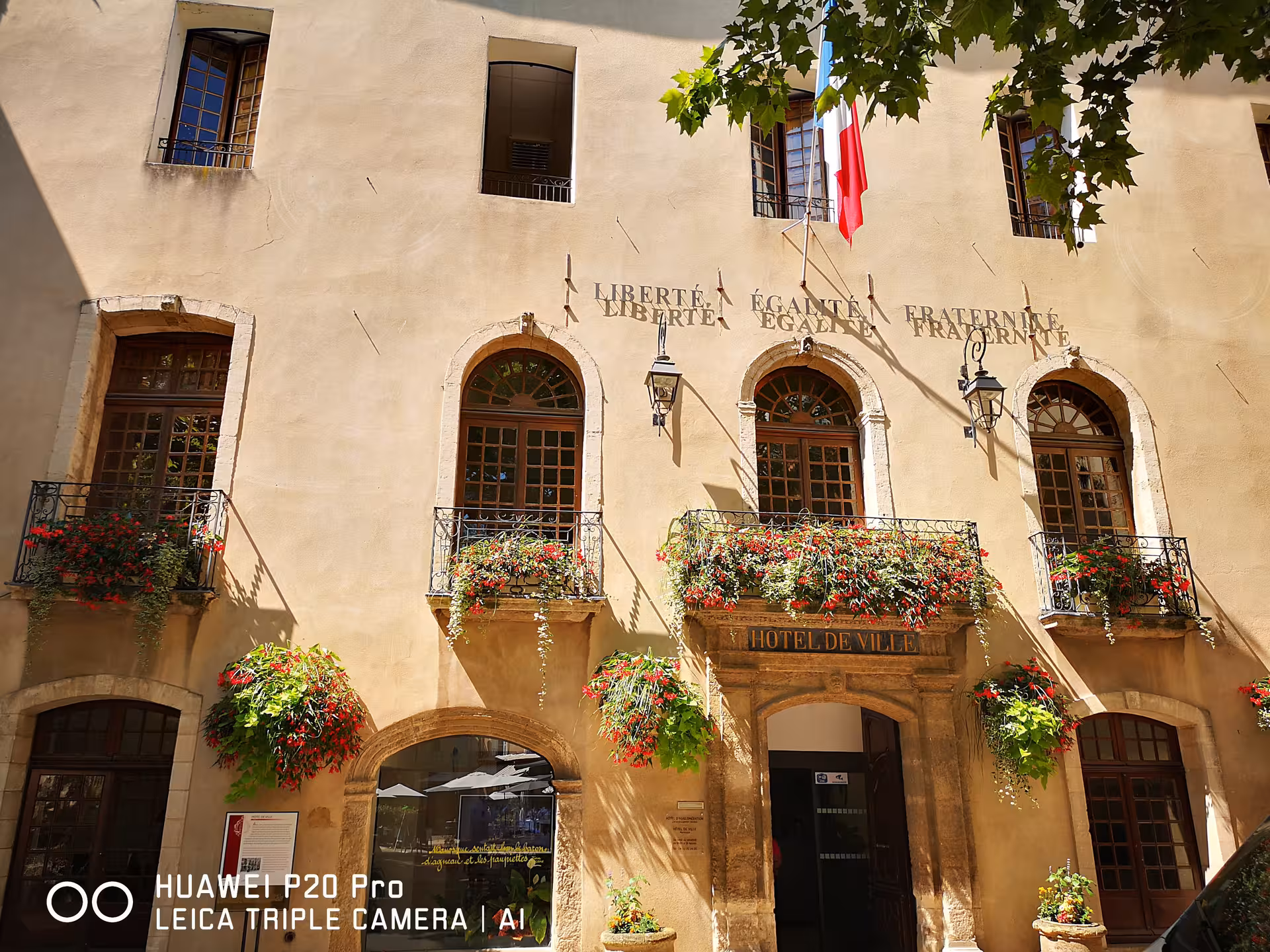 Hotel de Ville in Manosque with French flag and flower balconies, Marseille shore excursion to Provence