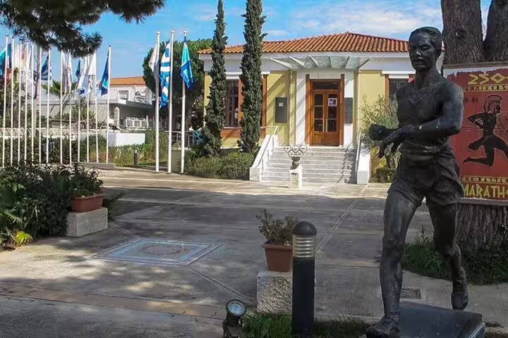 Marathon Archaeological Museum courtyard with runner statue, a stop on half-day Athens to Marathon tour