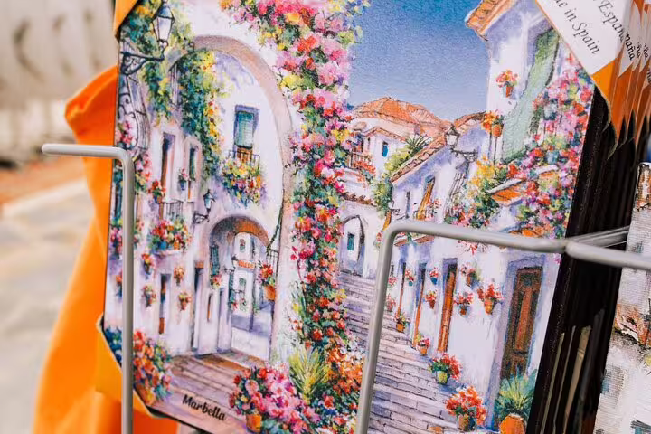 Colorful postcard depicting the picturesque floral streets of Marbella Old Town, Spain.