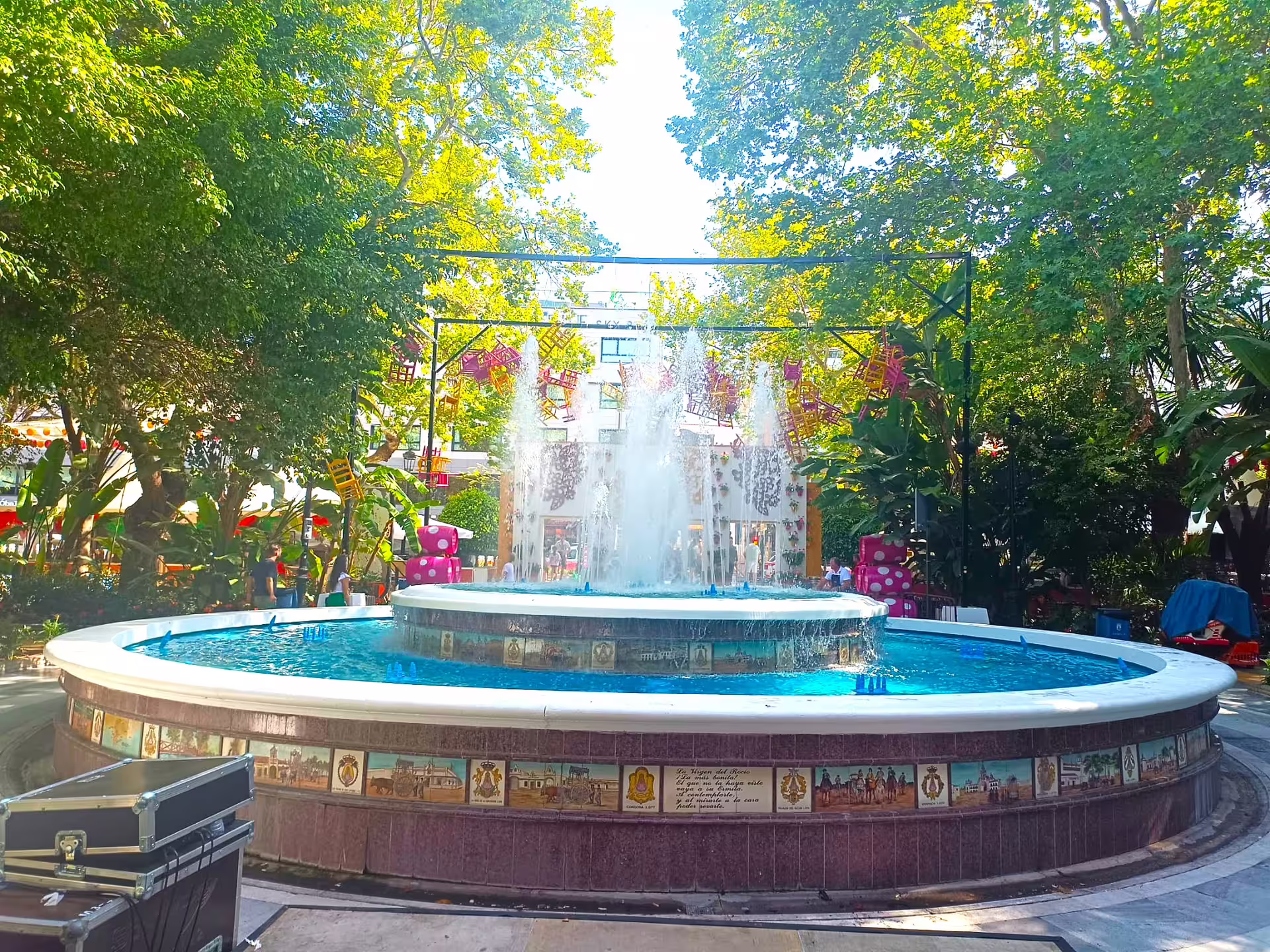 Marbella private tour from Malaga featuring a sunny park fountain and lively city center atmosphere on Costa del Sol