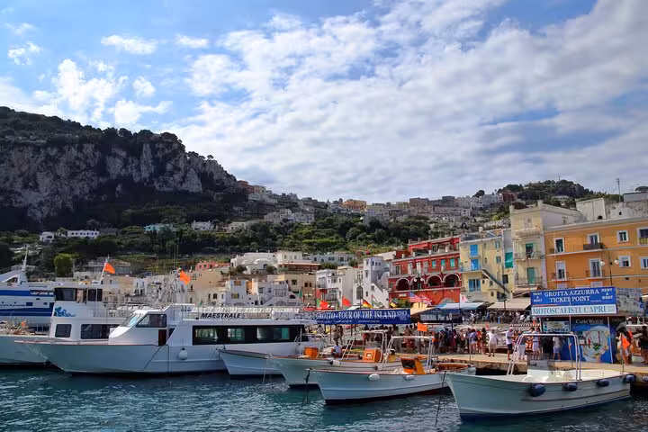 Vibrant Marina Grande port in Capri with colorful buildings and boats, ideal for Naples to Capri tours.