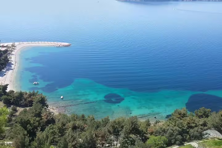 Aerial view of turquoise Adriatic cove near Split, scenic stop on Secret Marjan Park hiking tour