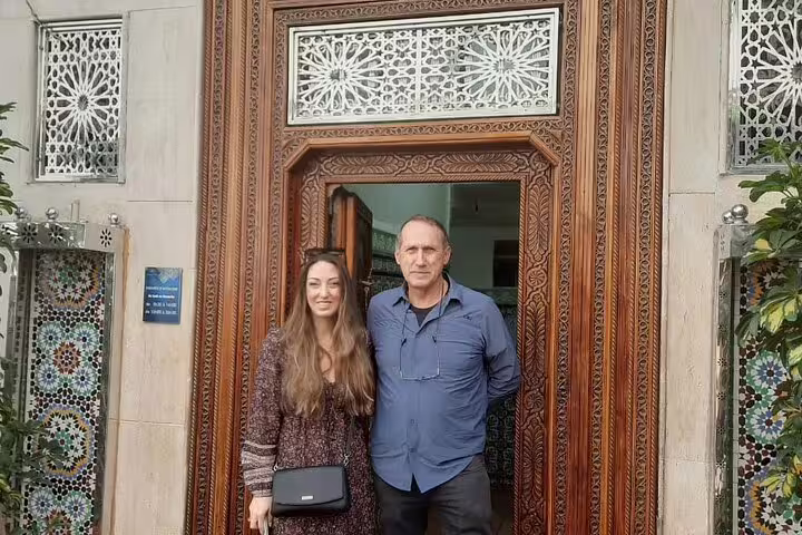 Travelers at a traditional Marrakech riad doorway, a highlight of the Morocco 12 days tour from Marrakech