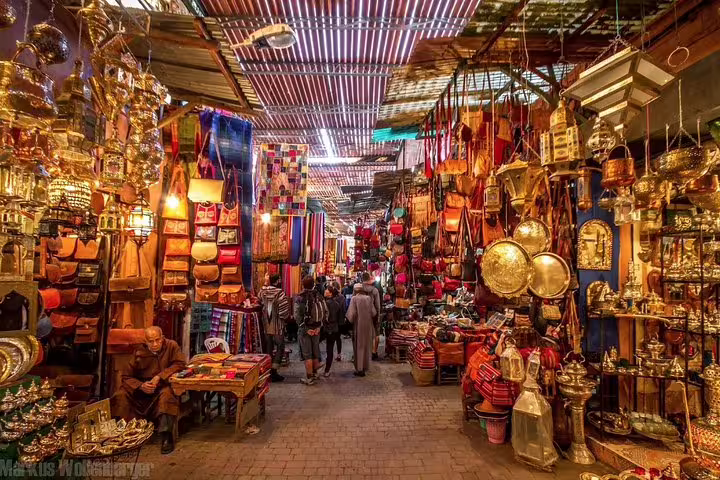 Bustling Marrakech souk with lanterns and leather goods, a highlight on Morocco Anti-Atlas Sahara 8-day tour