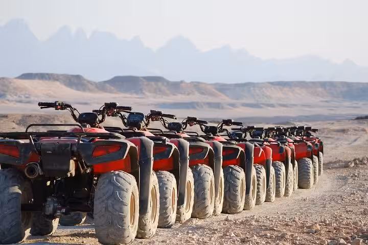 Line of quad bikes ready for Marsa Alam desert safari adventure with jeep, ATV ride and Bedouin dinner