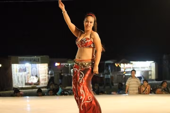 Belly dancer performing at Bedouin dinner show on Marsa Alam desert safari with jeep, quad and camel ride