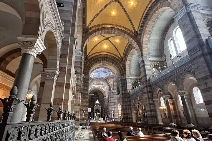 Inside Marseille Cathedral nave, arches and warm lights, seen on a private driver sightseeing tour of Marseille