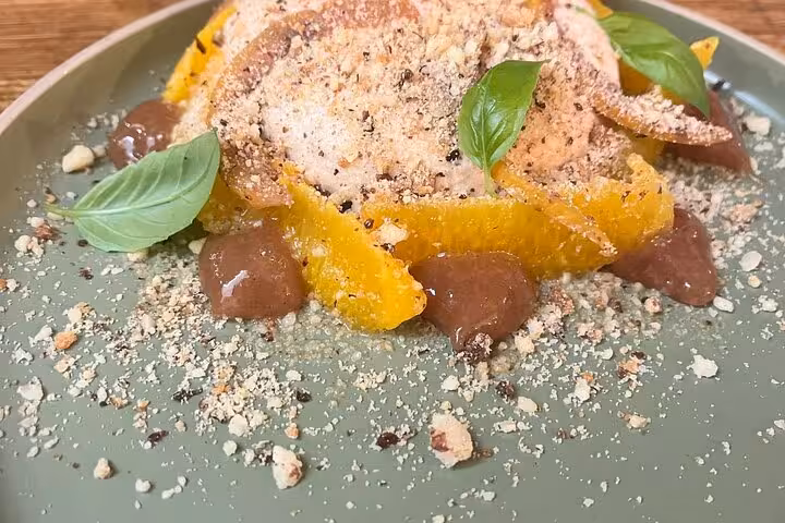 Marseille cooking workshop dessert plate with candied citrus, chocolate dollops, basil and nut crumble