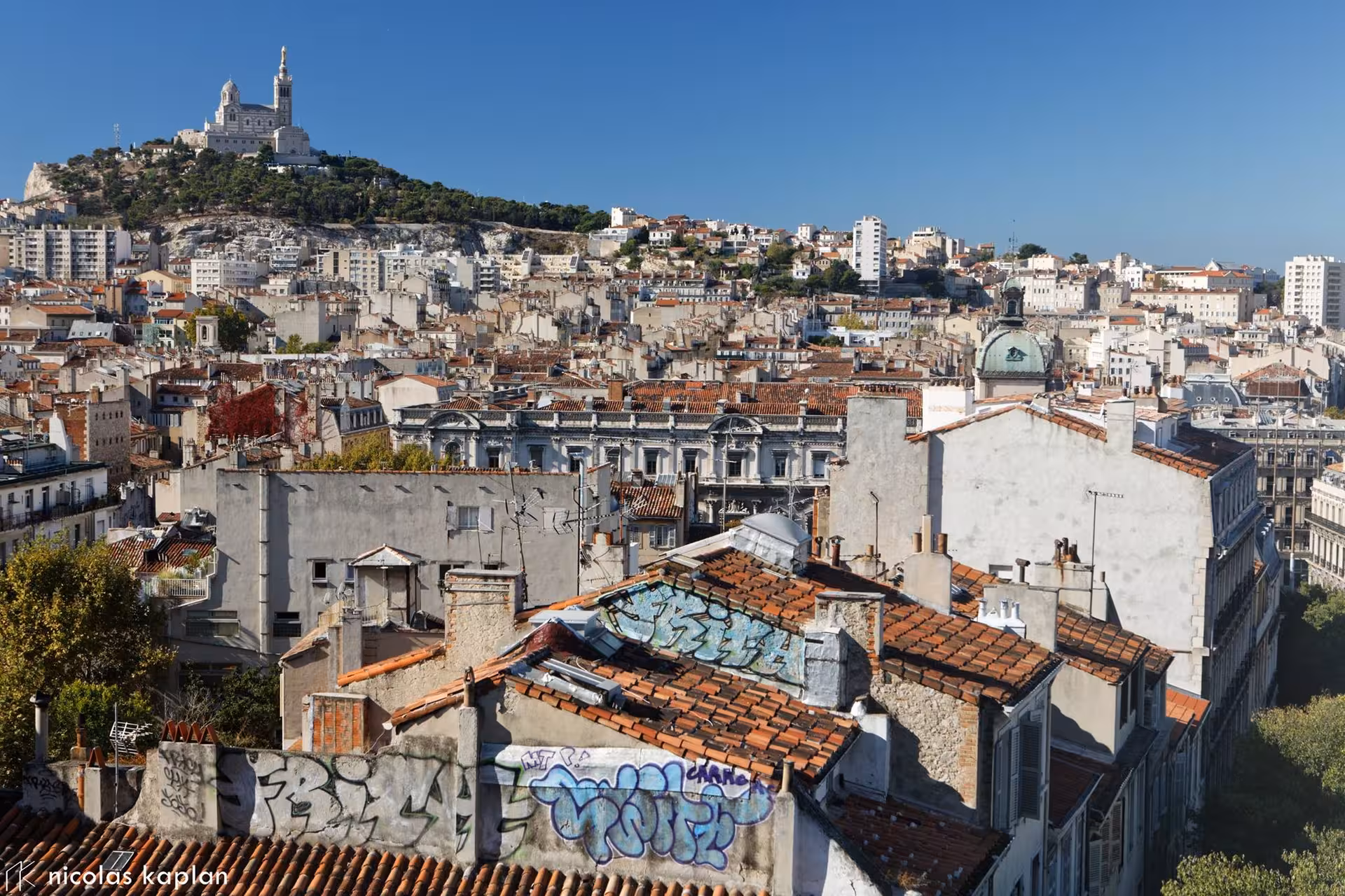 Playing pétanque in Marseille on a gravel court, a must-do local experience on a 3-day city tour