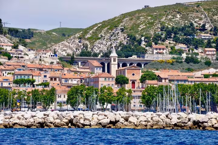 Marseille waterfront marina and hillside village view, scenic stop on a private driver sightseeing tour in Provence