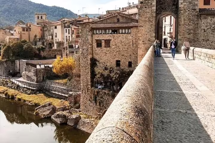 Picturesque medieval bridge leading to historic Besalú village, highlighting the charm of a private tour stop.