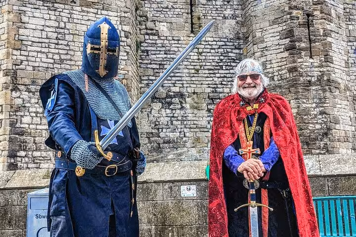 Medieval reenactors with swords at a Welsh castle, featured on the Portmeirion, Castles and Snowdonia tour