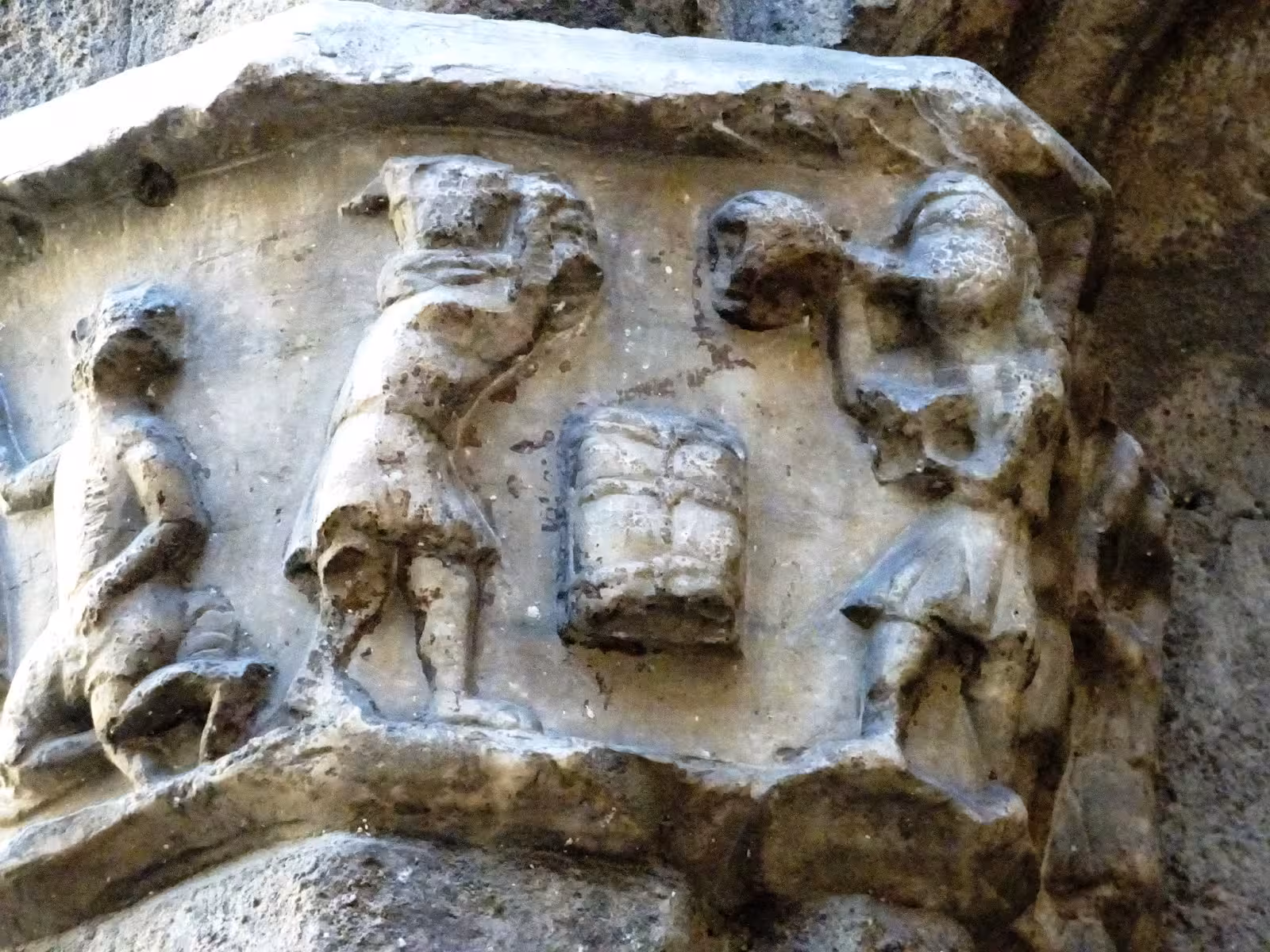 Intricate medieval stone carvings on a historic building facade in Barcelona's Ribera district.