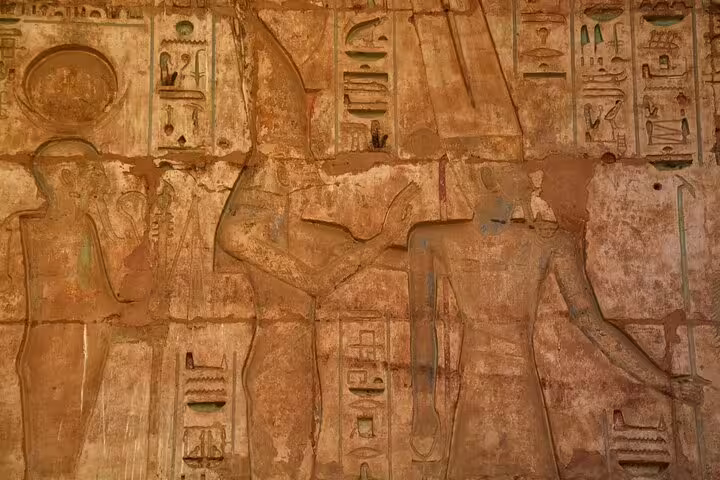 Close-up of ancient Egyptian wall relief and hieroglyphs at Medinet Habu on Luxor guided tour