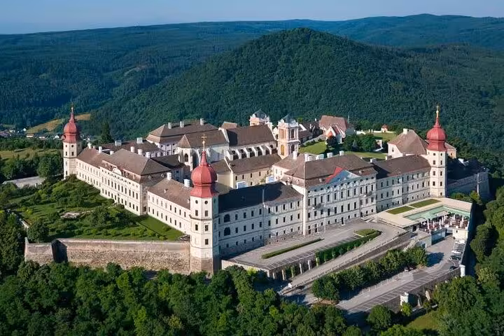 Aerial view of Melk Abbey on a Wachau Valley private tour from Vienna, showcasing baroque monastery and hills