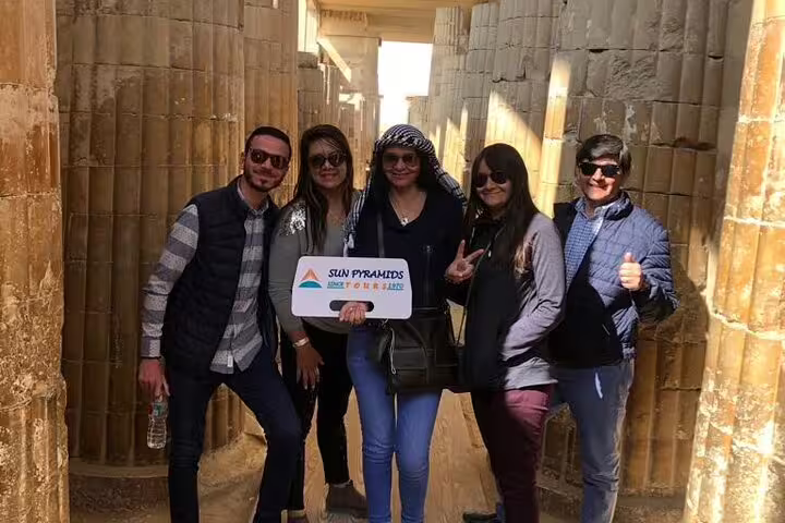 Travel group with guide inside ancient Memphis temple corridor on Pyramids, Memphis and Saqqara day tour